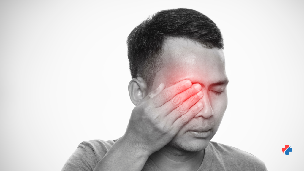 Man experiencing severe eye pain and vision discomfort that may require emergency evaluation